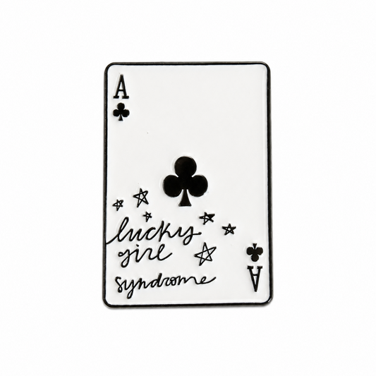 A single playing card styled like an Ace of Clubs card with the phrase 'lucky girl syndrome' in black script, shown on a plain white background.